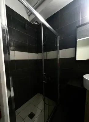 a bathroom with a glass shower with a sink at Monastiraki 101 SuperHost Hub in Athens