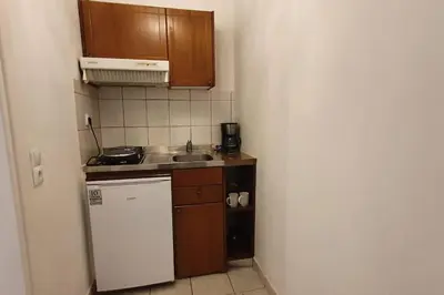 a small kitchen with a sink and a refrigerator at Lefti's Cosy Studio 40m2, Metro 7' in Athens