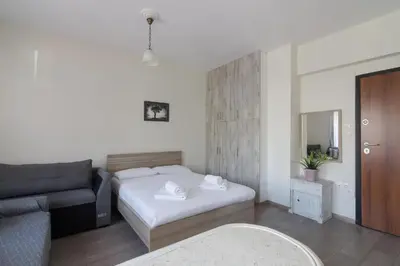 a small bedroom with a bed and a couch at Lovely Studio Apartment For 2 Ppl in Athens in Athens