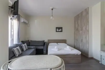 a living room with a bed and a couch at Lovely Studio Apartment For 2 Ppl in Athens in Athens