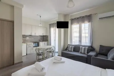 a living room with a couch and a table at Lovely Studio Apartment For 2 Ppl in Athens in Athens