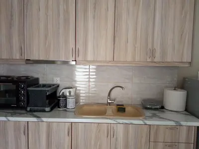 a kitchen counter with a sink and a microwave at AIOLOS LUXURY agios dimitrios center apartment 4 in Athens