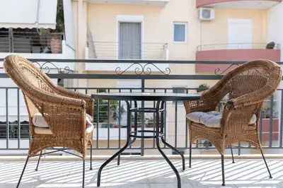 two chairs and a table on a balcony at AIOLOS LUXURY agios dimitrios center apartment 4 in Athens
