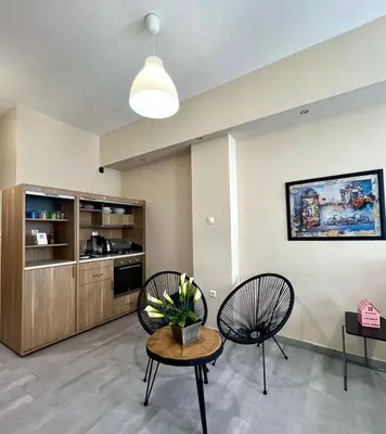 a living room with two chairs and a table at Monastiraki 103 SuperHost Hub in Athens