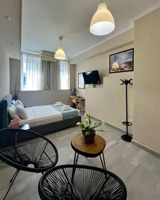 a living room with a bed and two chairs at Monastiraki 103 SuperHost Hub in Athens