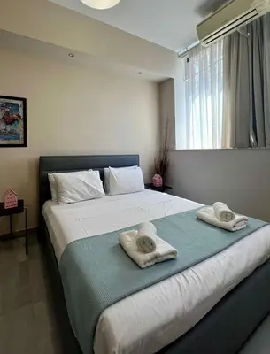 a bedroom with a large bed with towels on it at Monastiraki 103 SuperHost Hub in Athens