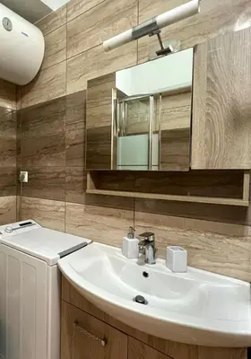 a bathroom with a white sink and a mirror at Monastiraki 103 SuperHost Hub in Athens