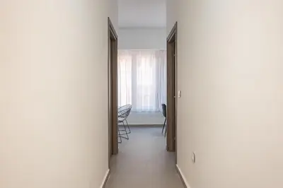 a hallway with a room with a table and chairs at Iguana Gold Luxury Suites 2 ( 1 min from Ermou street) in Athens