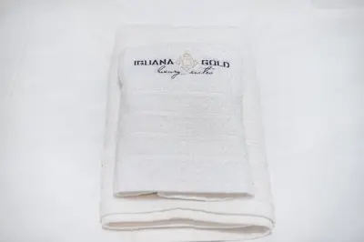 a stack of white towels sitting on a table at Iguana Gold Luxury Suites 2 ( 1 min from Ermou street) in Athens