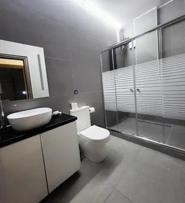a bathroom with a toilet and a sink and a shower at Iguana Gold Luxury Suites 2 ( 1 min from Ermou street) in Athens