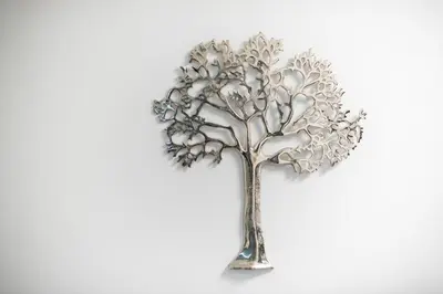 a silver tree ornament on a white background at Iguana Gold Luxury Suites 2 ( 1 min from Ermou street) in Athens