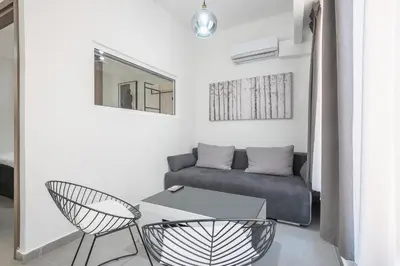 a living room with a couch and a table at Iguana Gold Luxury Suites 2 ( 1 min from Ermou street) in Athens
