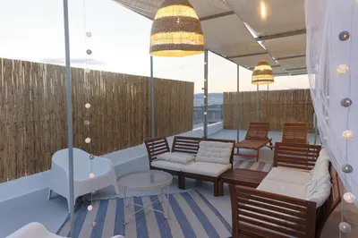 a balcony with chairs and tables on a ship at Rooftop studio with private terrace at Lycabettus Hill in Athens