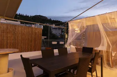 a black table and chairs on a balcony at Rooftop studio with private terrace at Lycabettus Hill in Athens
