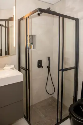a shower in a bathroom with a glass door at Rooftop studio with private terrace at Lycabettus Hill in Athens