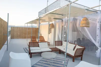 a patio with chairs and a table and some lights at Rooftop studio with private terrace at Lycabettus Hill in Athens
