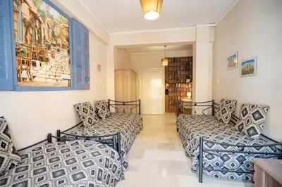 a room with two beds and a book shelf at Acropolis Athens 1 bedroom 4 pers apt by MPS in Athens