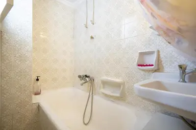 a bathroom with a shower and a sink and a tub at Acropolis Athens 1 bedroom 4 pers apt by MPS in Athens