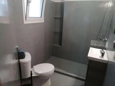 a bathroom with a toilet and a shower and a sink at Minimal Studio Varnava Square - Kallimarmaro Area in Athens