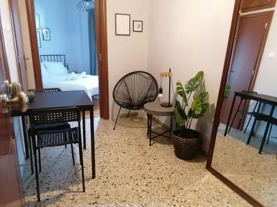 a room with a table and a chair and a mirror at Minimal Studio Varnava Square - Kallimarmaro Area in Athens