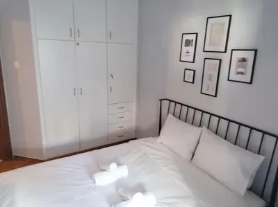 a bedroom with a white bed with two white pillows at Minimal Studio Varnava Square - Kallimarmaro Area in Athens