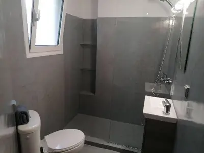 a bathroom with a toilet and a shower and a sink at Minimal Studio Varnava Square - Kallimarmaro Area in Athens