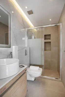 a bathroom with a sink and a shower and a toilet at Iconic Athens Suites in Athens