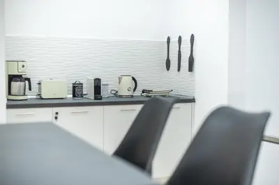 a kitchen with a counter and two chairs in a room at ATHENIAN HOME Near Acropolis in Athens