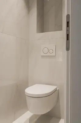 a white bathroom with a toilet and a shower at Spectacular 3BR Apartment in Pangrati by UPSTREET in Athens