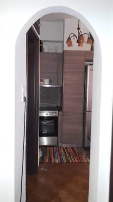 an open door to a kitchen with a stove at Κεντρικό διαμερισμα άνετο κ ήσυχο in Athens