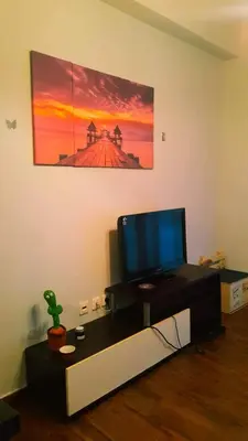 a living room with a flat screen tv on a table at Κεντρικό διαμερισμα άνετο κ ήσυχο in Athens