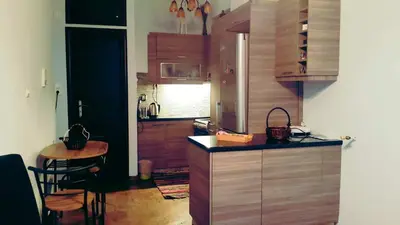 a kitchen with a table and a counter top at Κεντρικό διαμερισμα άνετο κ ήσυχο in Athens