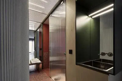 a glass door leading to a bathroom with a sink at The Newel Metaxourgeio by Athens Stay in Athens