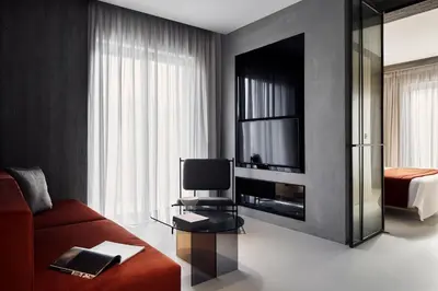 a living room with a red couch and a television at The Newel Metaxourgeio by Athens Stay in Athens