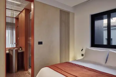 a bedroom with a bed and a large window at The Newel Metaxourgeio by Athens Stay in Athens