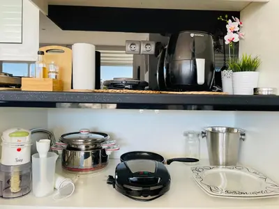 a kitchen counter with pots and pans on a stove at Luxury Penthouse Studio with Sea View, Palaio Faliro in Athens