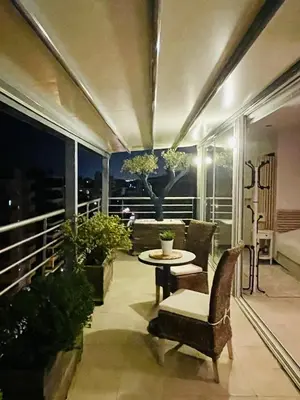 a balcony with a table and chairs on a balcony at Luxury Penthouse Studio with Sea View, Palaio Faliro in Athens