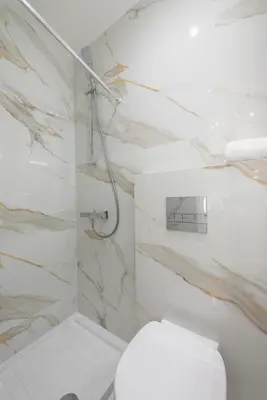 a white bathroom with a toilet and a shower at SYNTAGMA MINI in Athens