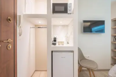 a small bathroom with a microwave and a chair at SYNTAGMA MINI in Athens