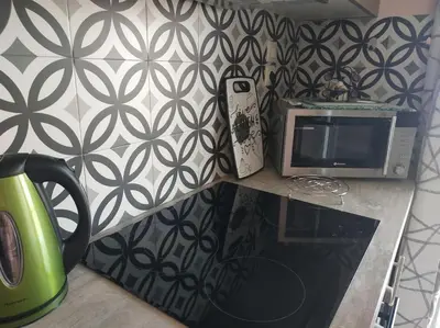 a kitchen counter with a microwave and a phone on it at Athens view apartment near Metro station Agia Marina in Athens