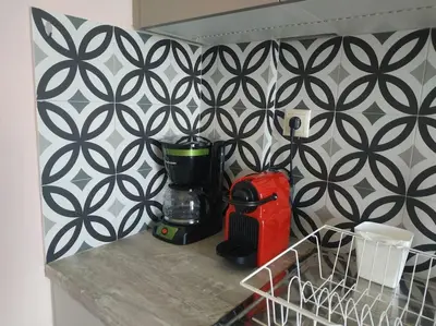 a kitchen counter with a coffee maker on a counter top at Athens view apartment near Metro station Agia Marina in Athens