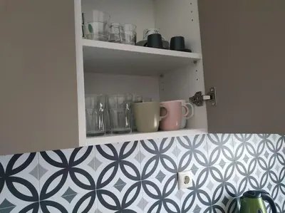 a cupboard with cups and mugs on it at Athens view apartment near Metro station Agia Marina in Athens