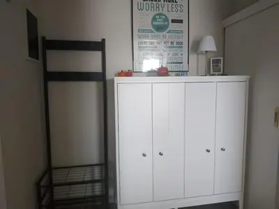 a white cabinet in a room with a bed at Athens view apartment near Metro station Agia Marina in Athens
