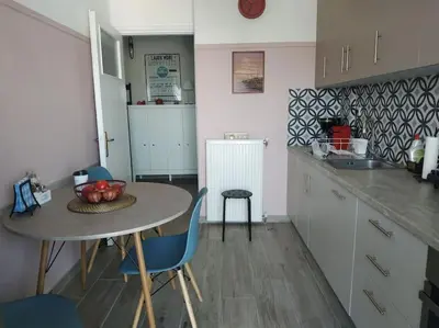 a kitchen with a table and chairs and a sink at Athens view apartment near Metro station Agia Marina in Athens