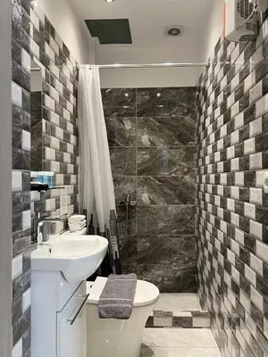 a bathroom with a sink and a toilet and a shower at Historic Center getaway 10'walk to Acropolis hill in Athens