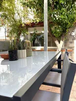 a glass table with potted plants on a patio at Historic Center getaway 10'walk to Acropolis hill in Athens