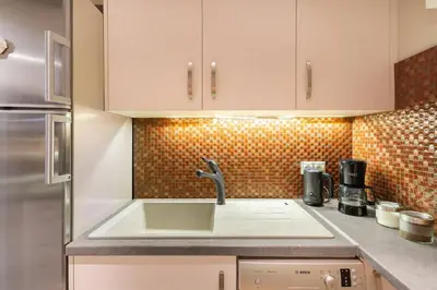 a kitchen with a sink and a counter top at Stylish King size bed apt steps from Acropolis by GHH in Athens