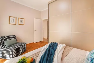 a room with a bed and a chair and a mirror at Stylish King size bed apt steps from Acropolis by GHH in Athens