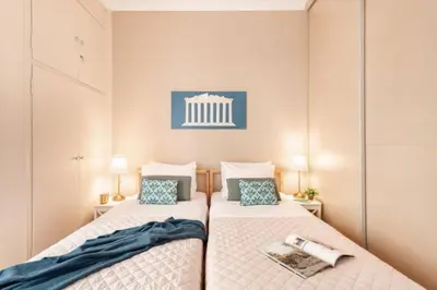 two beds in a small room with two lamps at Stylish King size bed apt steps from Acropolis by GHH in Athens