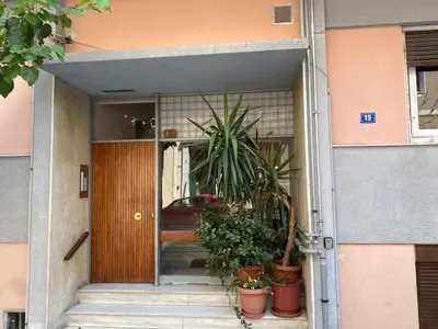 a front door of a house with potted plants at Stylish King size bed apt steps from Acropolis by GHH in Athens